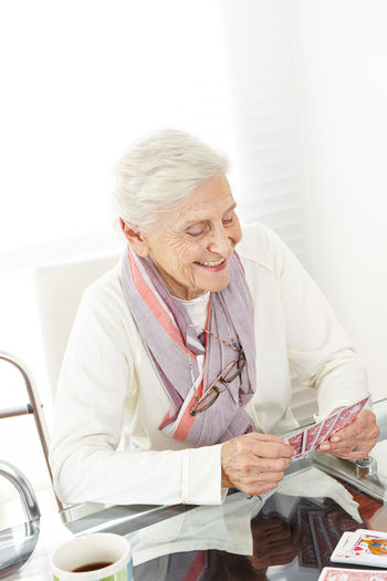 Senior woman playing cards at hospital