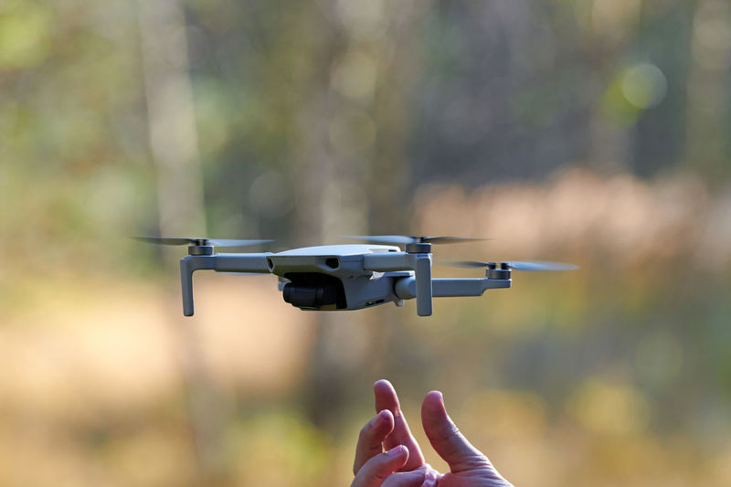 Quadcopter drone on operator hand. small drone land on hand after taking video and photos