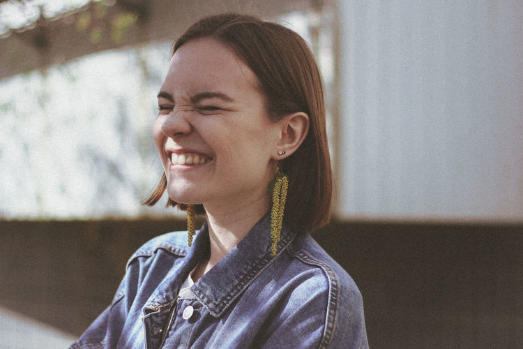Close-up of smiling woman with eyes closed