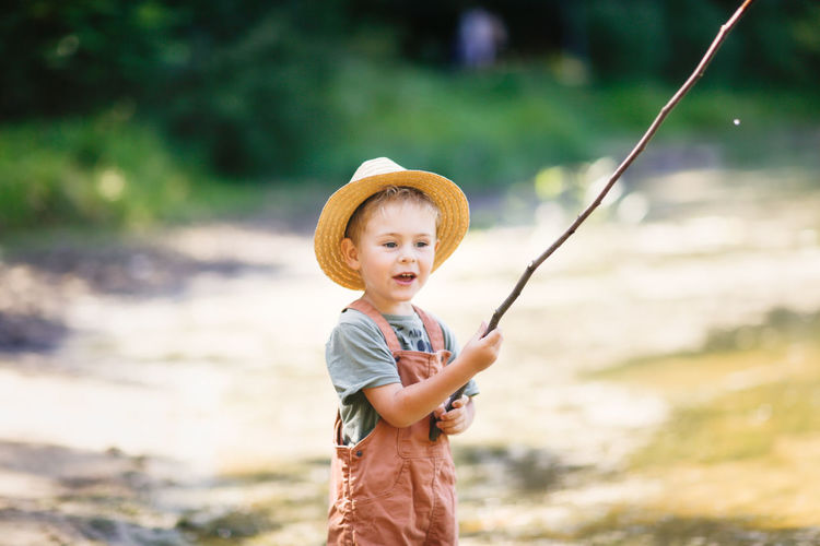 Cute boy fishing in river