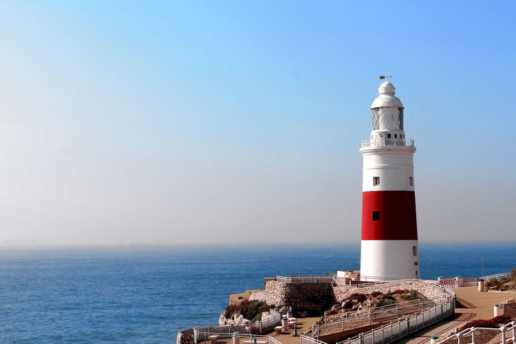 Lighthouse against calm blue sea