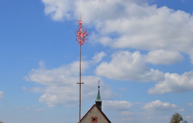 Low angle view of communications tower and building against sky