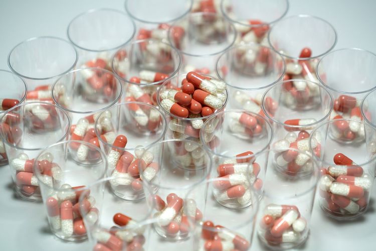 High angle view of capsules in glasses on table