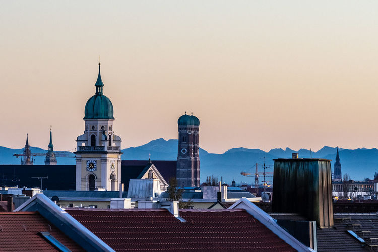 Frauenkirche of munich during sunset with the alps in the background