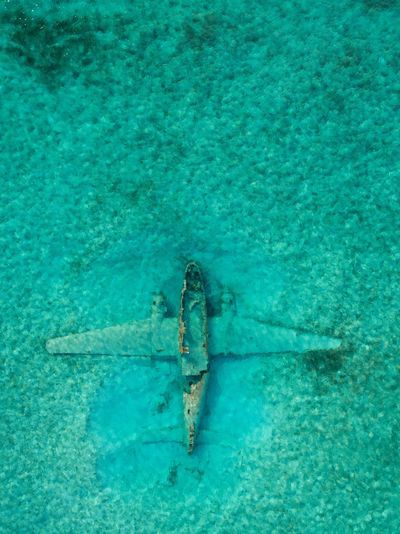 Aerial view of abandoned airplane in sea