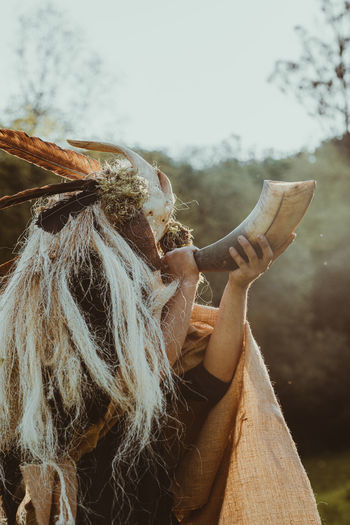 Shaman invoking the spirits in a ceremony in a forest