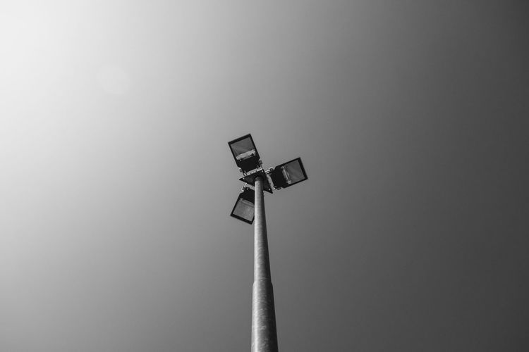 Low angle view of communications tower against sky