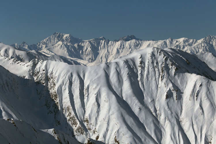Panoramic view of snowcapped mountains against clear sky. gudauri, georgia