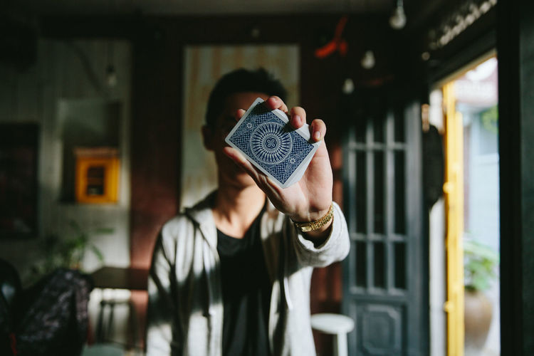 A man with cards in his hand Cards Casual Clothing Day EyeEm EyeEm Best Edits EyeEm Best Shots Eyeem Collection EyeEm Gallery Focus On Foreground Fresh On Eyeem Fresh On The EyeEm Hairstyle Hand In Front Of Indoors Photooftheday VSCO Vscocam Waist Up Young Adult
