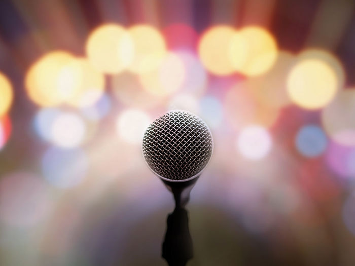 Close-up of microphone against illuminated lights