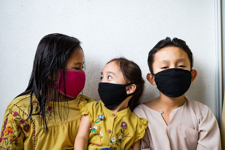 Asian young kids are wearing hygienic reusable face mask to prevent the virus. new normal.