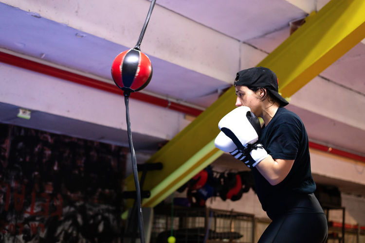 Boxer woman training at the punching ball