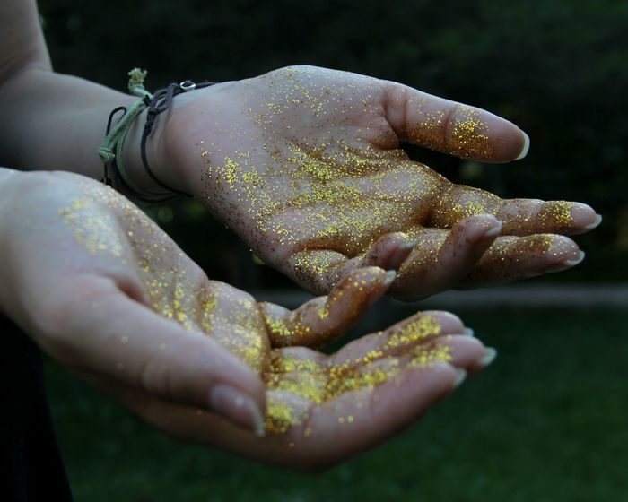 Cropped image of woman with glitter on hands