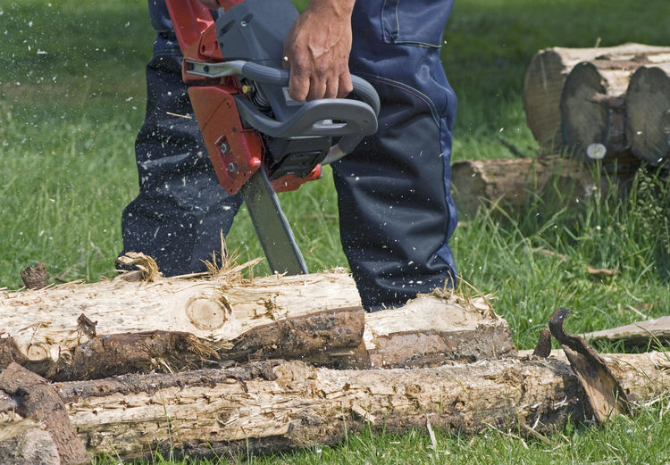 Low section of man working on wood