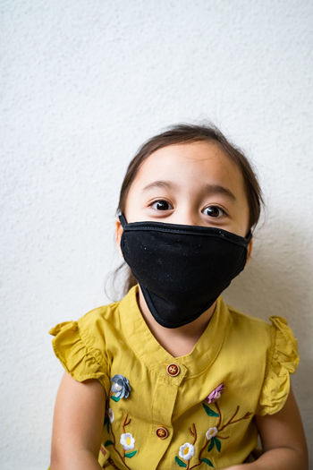 Asian young kids are wearing hygienic reusable face mask to prevent the virus. new normal.