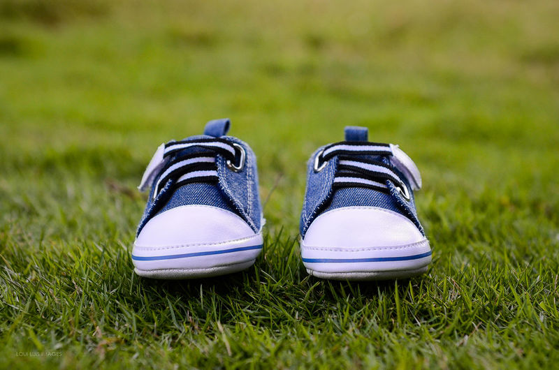 Close-up of shoes on grass