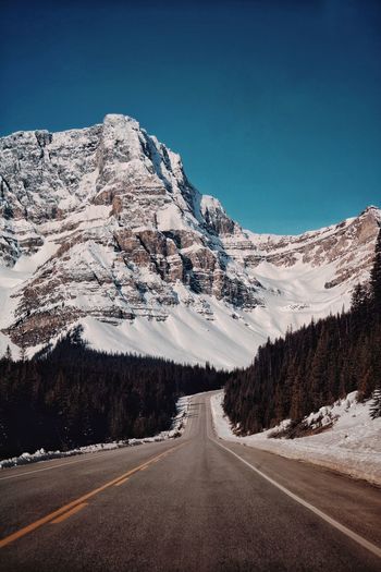 Road against snowcapped mountains 