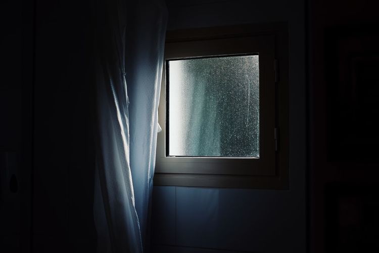 Close-up of window in dark room