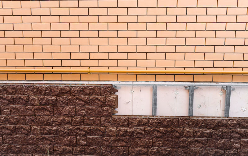 Brick wall and masonry applied to the facade of a building, house construction. 