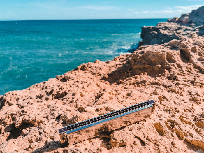 Harmonica on a cliff above the sea