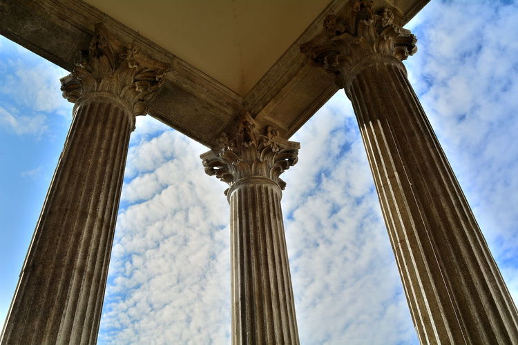 Low angle view of colonnade against sky
