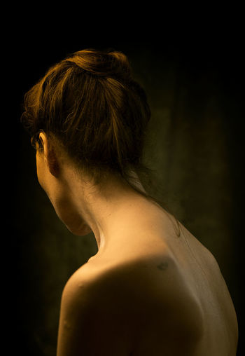 Woman from behind between lights and shadows ii