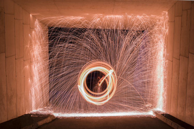 Steel wool photograph with sparks framed in a tunnel
