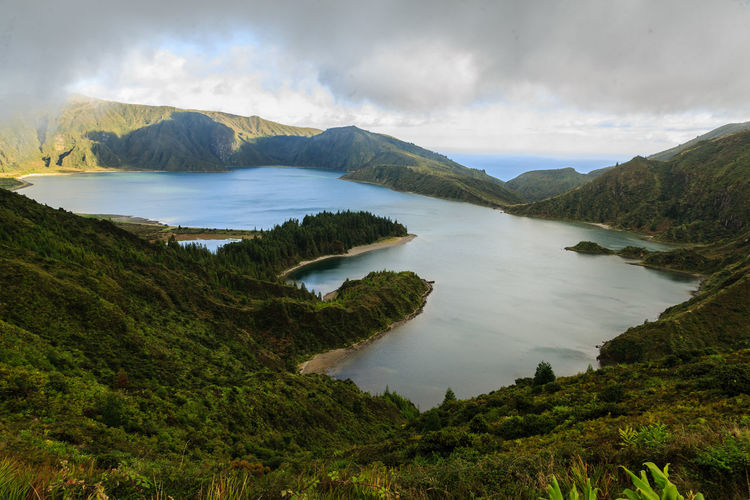 Scenic view of lake and mountains against sky