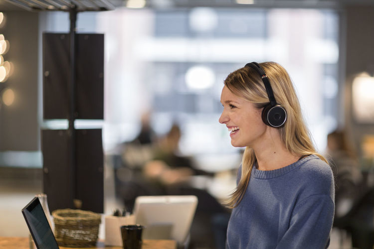 Woman wearing headset in office