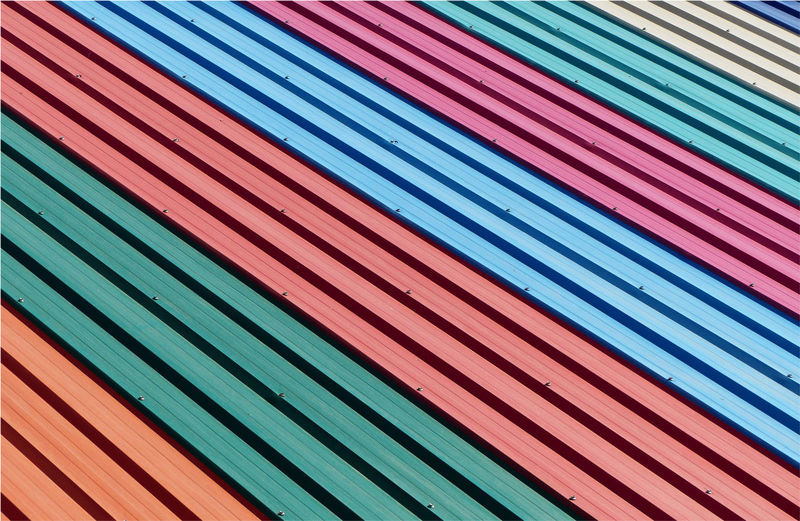 Full frame shot of multi colored metal sheet of roof pattern