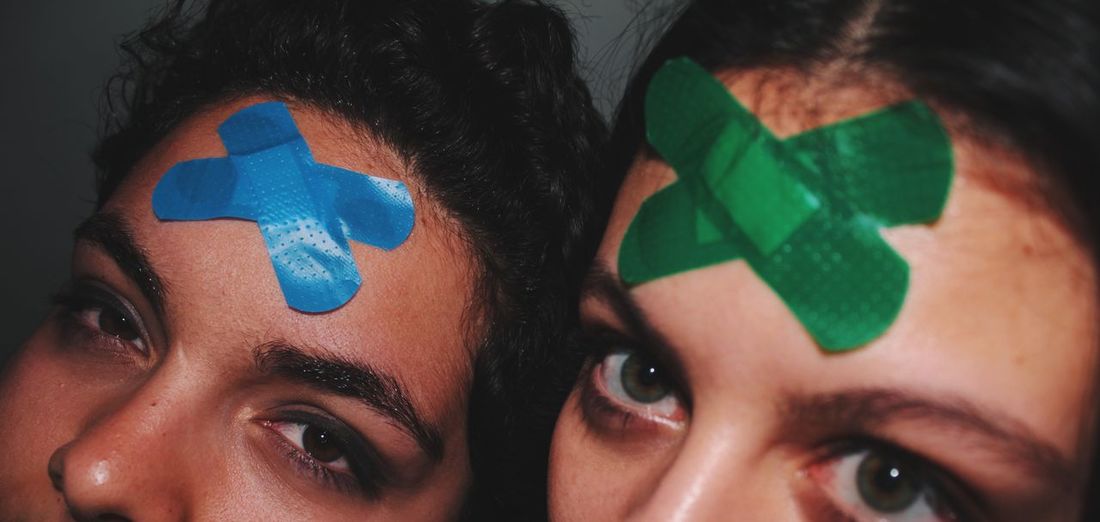Close-up portrait of girls with plasters in face