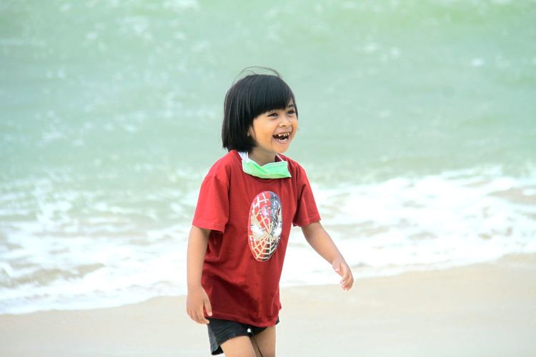 Cute girl standing on beach