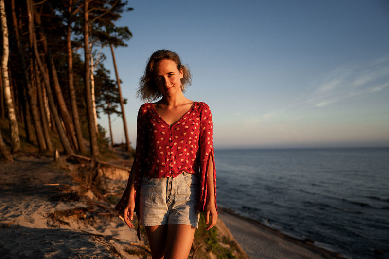 Portrait of teenage girl standing on shore