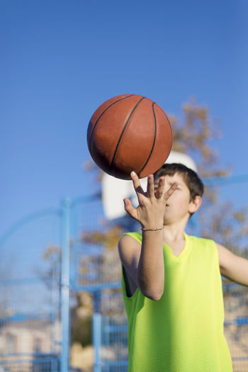 Boy playing with basketball