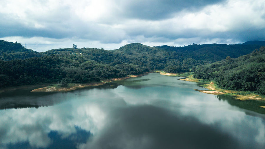 Mountain view with reflection on the lake, have cloudy sky in cinematic tone
