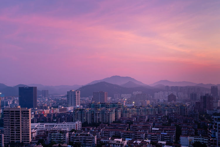 Buildings against sky during sunset