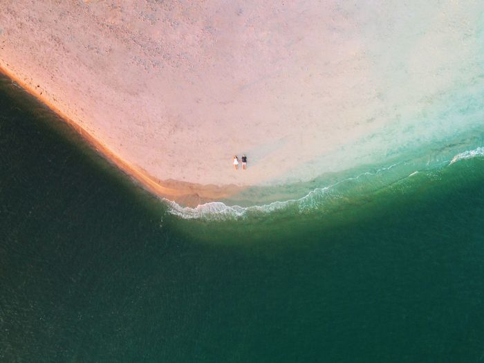 Aerial view of couple lying on the beach