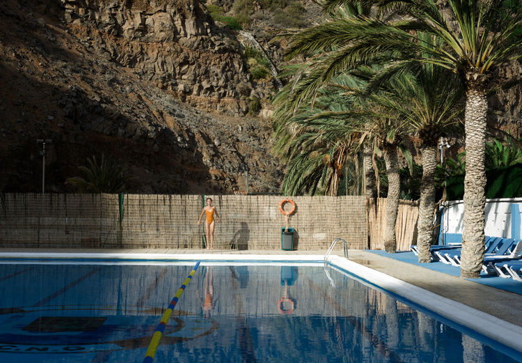 Woman on poolside at swimming pool