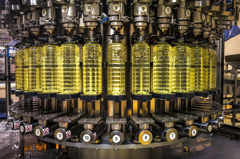 Close-up of machinery with bottles in factory
