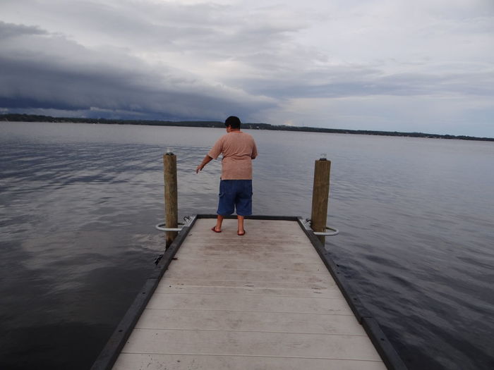 Woman standing on jetty in lake