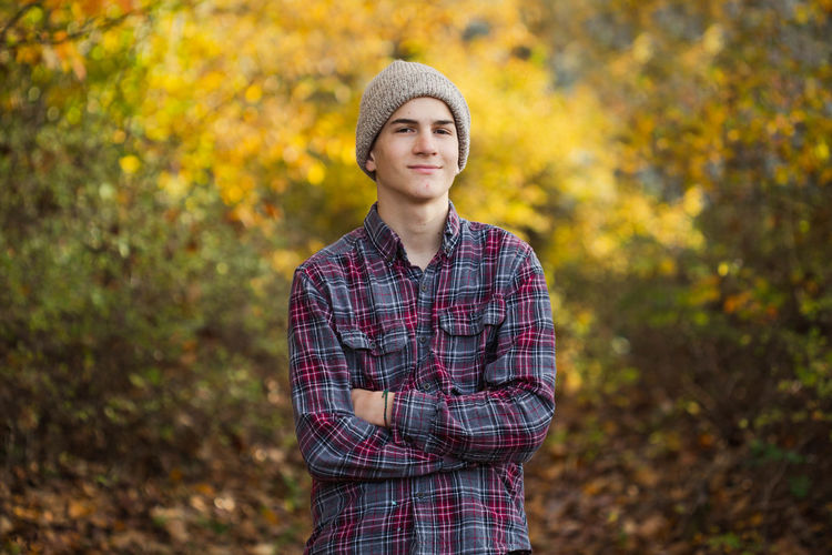 Portrait of man standing against tree during autumn