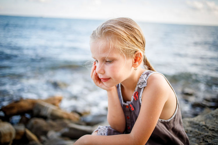 Mid adult woman sitting on beach