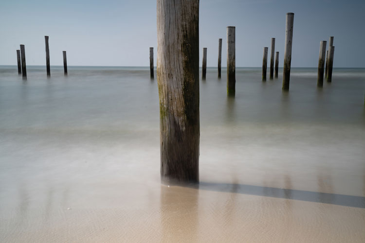 Long exposure, at the north sea in petten with the pole village in the sea, focus on foreground.