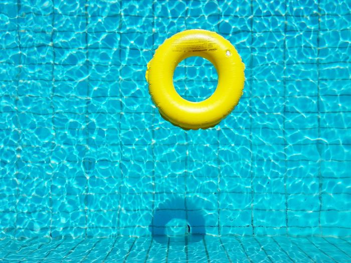 High angle view of yellow rubber ring in the pool