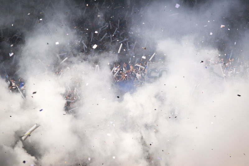 Fans with smoke in soccer stadium