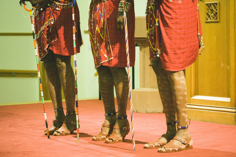 Low section of people in masai costume performing on stage