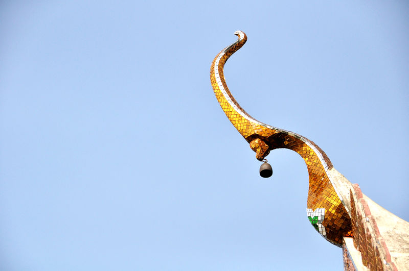 Low angle view of statue against clear blue sky