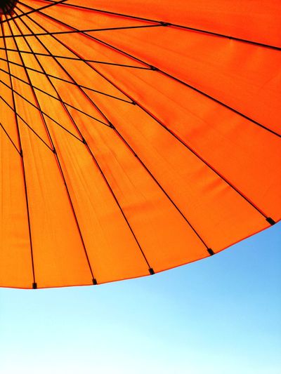 Low angle view of parasol against sky