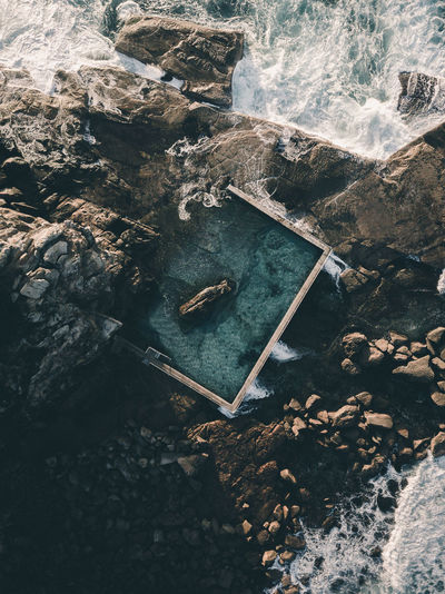 High angle view of swimming pool by rocks