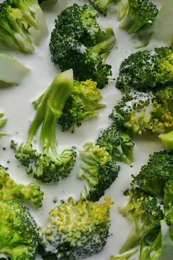 High angle view of broccoli with coconut milk